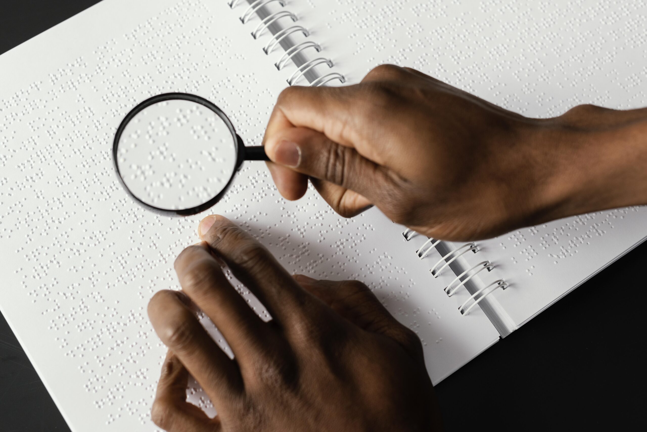 close up hand with magnifying glass 1 scaled